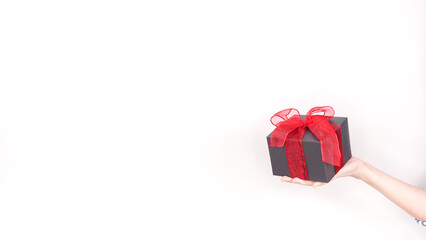 Elegant Black Gift Box with Vibrant Red Ribbon Bow on a Clean White Background for All Occasions