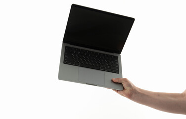 Person holds a laptop with a black screen in a bright setting showcasing a tech device in use