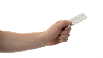Hand holding a strip of white pills against a plain background showcasing health and wellness