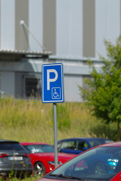 A clearly marked handicapped parking sign positioned within a designated parking lot, ensuring accessibility for those in need of special accommodations and spaces