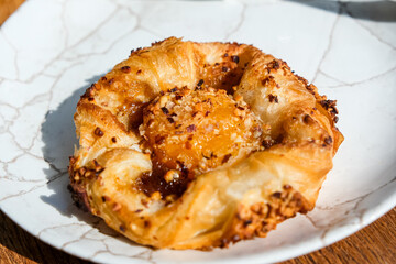 Peach danish pastry. Simple sweet breakfast bun. Pastry on a plate. Crispy delicious breakfast