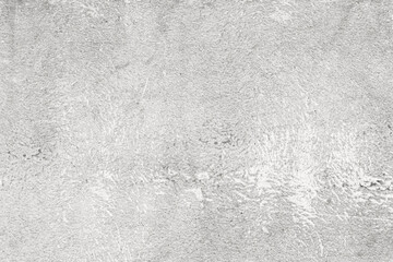 Fototapeta premium A rough white concrete surface with textured irregularities, small pits, and a raw industrial finish