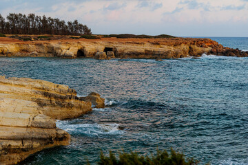 Eroded Coastal Cliffs by the Mediterranean Sea, Golden coastal rock formations shaped by erosion,...