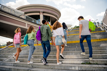 Students walking up city stairs enjoying summer day together, representing friendship and adventure in the urban environment.