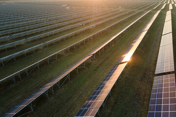Aerial view of large sustainable electrical power plant with rows of solar photovoltaic panels for...