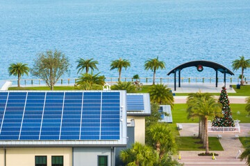 Autonomous building in Florida with photovoltaic rooftop covered with solar panels for producing of...
