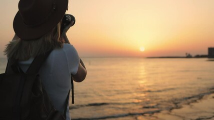 Silhouetted photographer framing golden hour seascape with radiant sunset highlighting dramatic ocean horizon and luminous sky hues. Travel, blogging, weekend, relax and lifestyle concept - Powered by Adobe