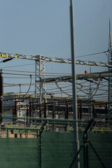 A securely fencedin area that contains an abundance of power lines running through it, creating an...