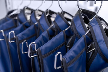 A rack of lead aprons used for protection from Xray, x-ray, x ray beam in operating room or dentist...