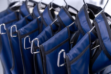 A rack of lead aprons used for protection from Xray, x-ray, x ray beam in operating room or dentist or radiologist, hospital. radiation protective vest.