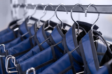 A rack of lead aprons used for protection from Xray, x-ray, x ray beam in operating room or dentist or radiologist, hospital. radiation protective vest.