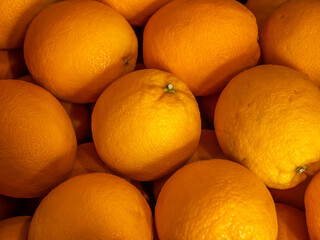 Close-up of fresh oranges in warm light. Healthy, juicy citrus fruits rich in vitamin C, perfect...