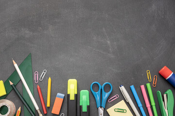 Back to school background with copy space. Variety of Office and school supplies on Blackboard background © Abdull