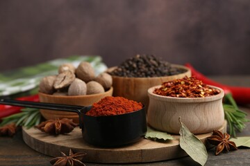 Many different aromatic spices on wooden table