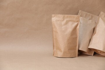 Zipper stand-up pouches on kraft paper background. Mockup for design