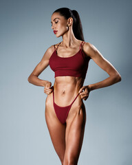 An Elegant and Athletic Woman Posing Gracefully in Stylish and Trendy Swimwear Apparel
