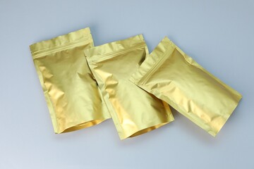 Zipper stand-up pouches on light grey background, flat lay. Mockup for design