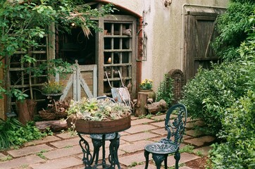 Rustic Garden Scene with Vintage Furniture and Lush Greenery