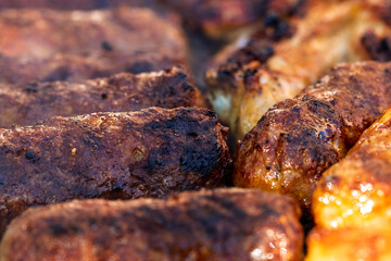Pork chops, steak, sausages on barbecue grill