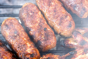 Pork chops, steak, sausages on barbecue grill
