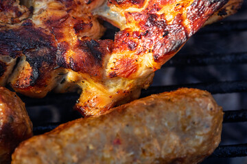 Pork chops, steak, sausages on barbecue grill