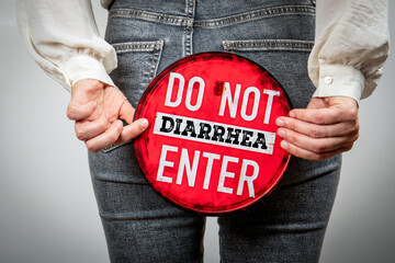 Humorous Health Warning Sign About Digestive Issues Held Behind Back