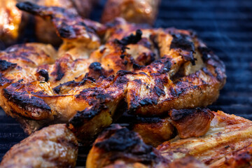 Pork chops, steak, sausages on barbecue grill