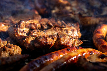 Pork chops, steak, sausages on barbecue grill