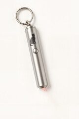 Metallic cat laser pointer isolated on light background