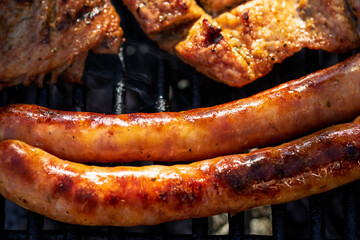 Pork chops, steak, sausages on barbecue grill