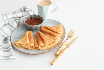 Crepes with chocolate cream and coffee on white wooden table. Pancake day, Maslenitsa