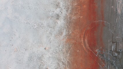 Aerial view of a salt lake coastline with strips of various bright colors.