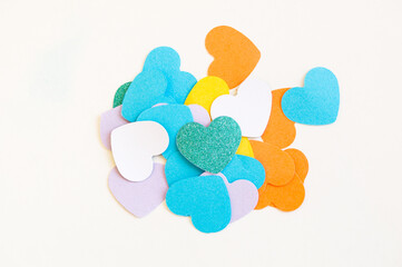 Cut-out hearts of different colors as a concept of love