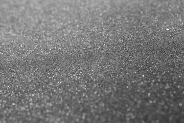 Black glitter abstract background texture. Full frame. Selective focus
