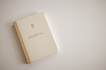 Elegant journal with floral design on neutral background  