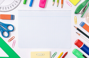 Blank graph paper sheet and School and office supplies around. Back to school background. Flat lay...