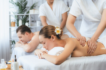 Caucasian couple customer enjoying relaxing anti-stress spa massage and pampering with beauty skin...