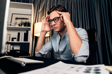 Thinking of stressful financial analyst researching on business paragraph on pc screen with dynamic...