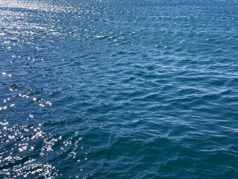 Glittering ocean water rippled surface.