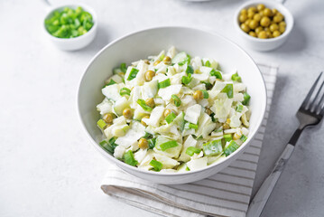 Cabbage cucumber green peas mayonnaise salad in a bowl