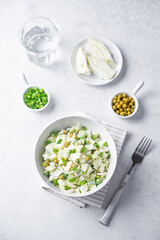 Cabbage cucumber green peas mayonnaise salad in a bowl