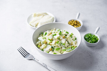 Cabbage cucumber green peas mayonnaise salad in a bowl