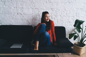 Relaxed freelancer smiling and taking break after completing work task, showing balance between...