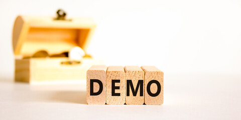 Demo symbol. Concept word Demo on beautiful wooden blocks. Beautiful wooden chest with coins....