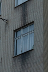 A large structure featuring an extensive number of windows adorning its exterior, creating a bright and open atmosphere within