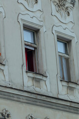 There is a striking building that features a vibrant red curtain elegantly draped across its large...