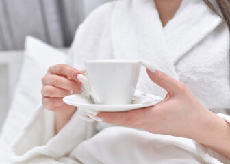 young girl drinking coffee in the morning at the hotel. solo travel