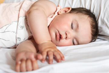 Cute little baby sleeping in bed at home