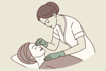Rejuvenating beauty treatment as a professional performs a careful face massage with gloves.