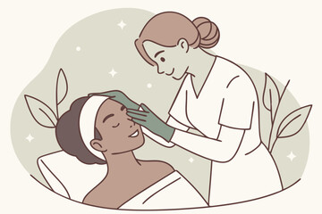 Tranquil beauty session as a cosmetologist in gloves gently massages a woman’s face.